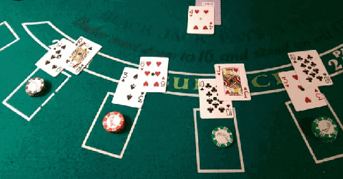 blackjack cards and chips on a blackjack table